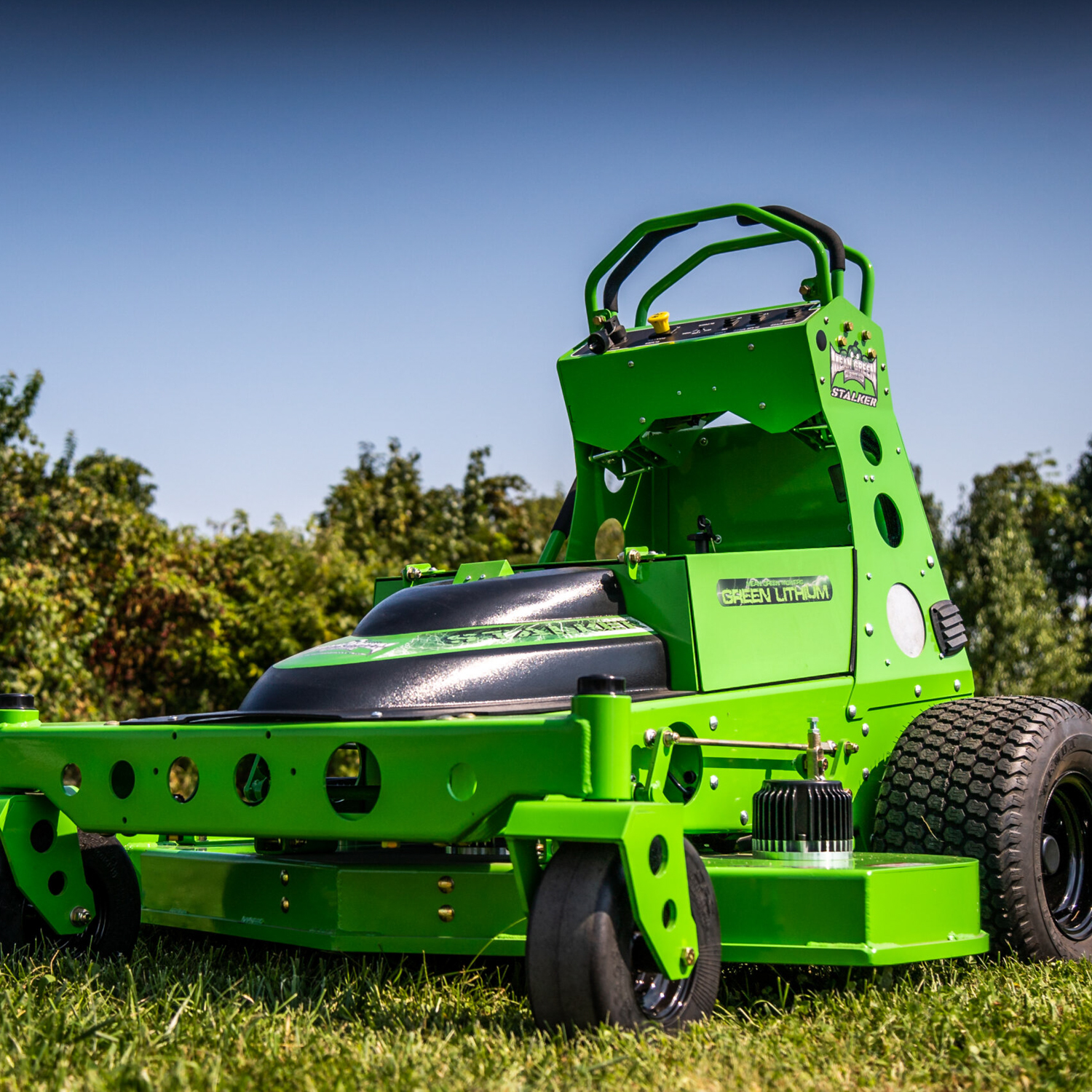 Bright green electric mower in grass.