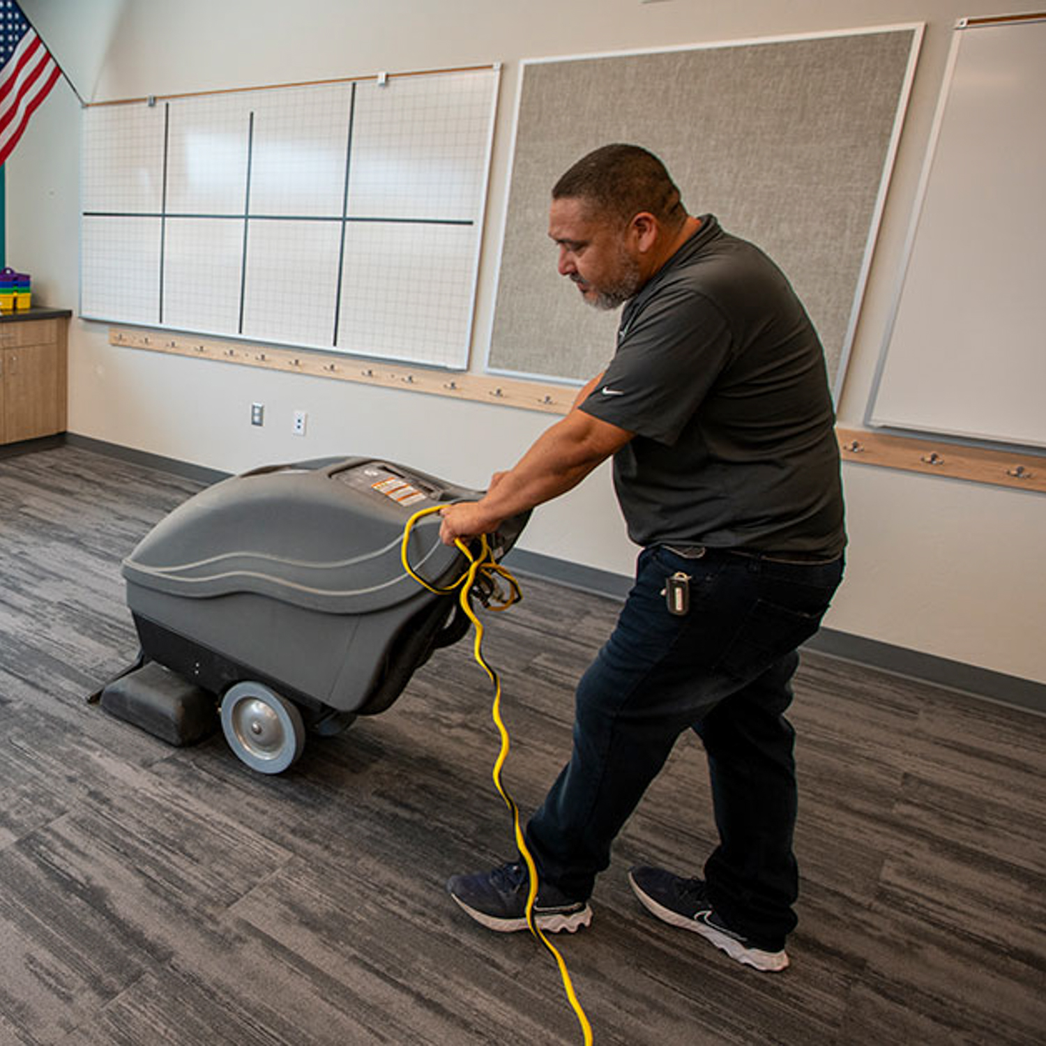 Vacuuming school classroom.