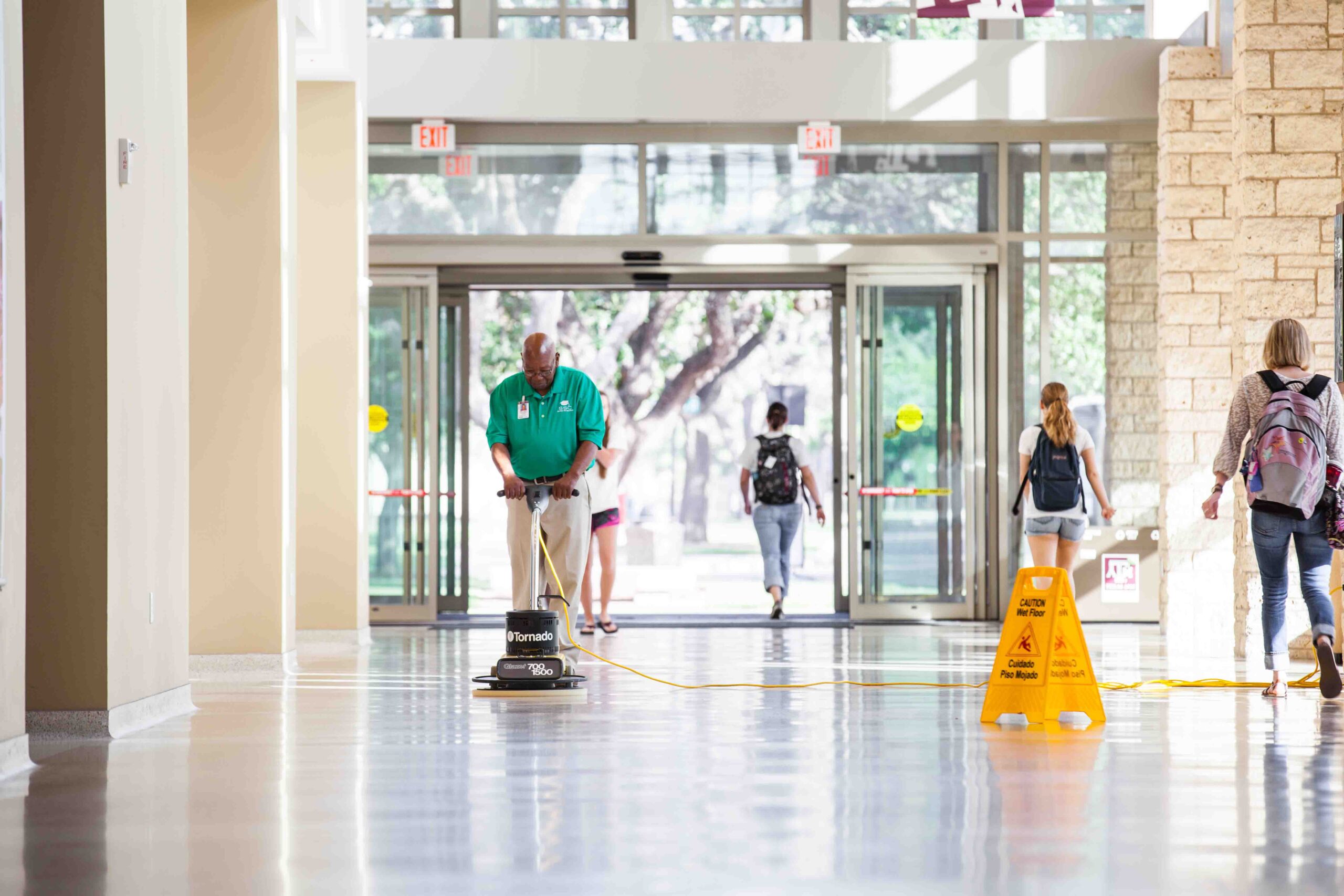 man using floor scrubber at a college