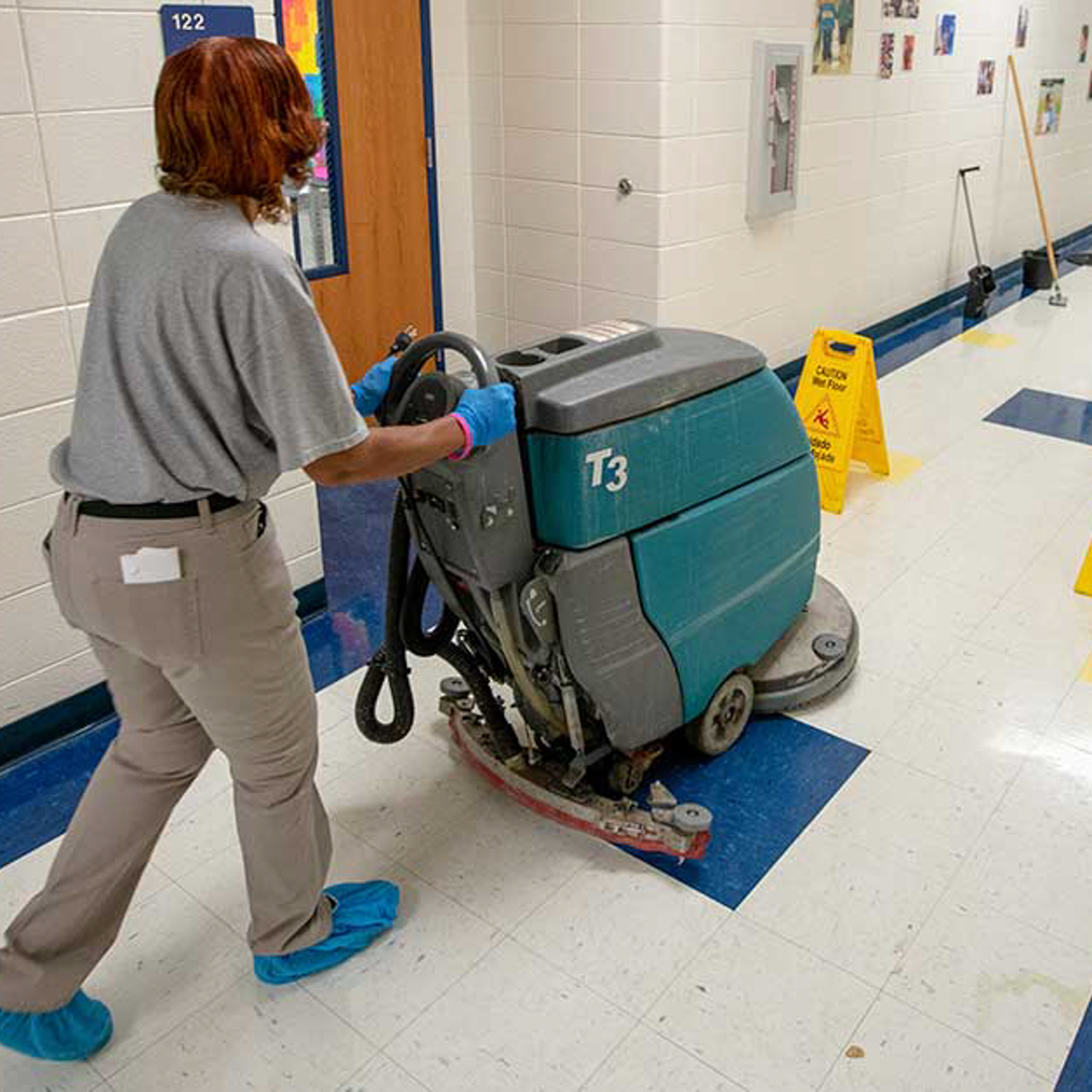 Cleaning school hallway floor.